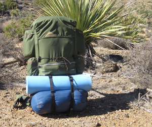 Sleeping bag strapped to the bottom of a backpack