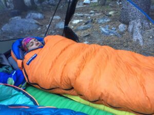 Insulated sleeping bag with heat trapping hood